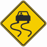 Slippery When Wet Road Sign
